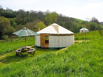 Yurt and family yurt tucked into the hill
