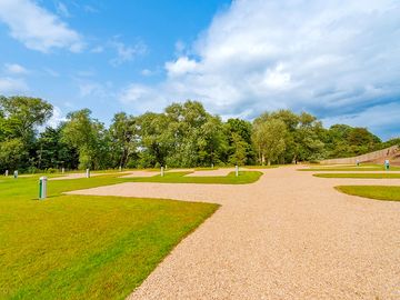 Ornate gravel driveways and pitches with hardstanding pitches to the left (added by manager 18 dec 2023)