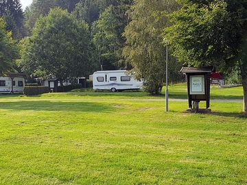 Level grass pitches backed by trees