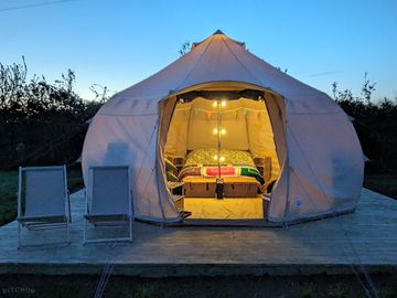 Bell tent outside at night. (added by manager 29 apr 2024)