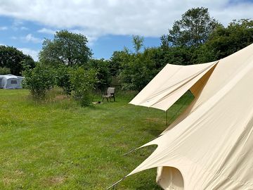 Western edge bell tent has its own shower / toilet and fire pit.