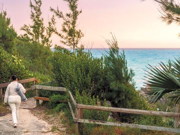 A guest enjoying a brisk walk along a scenic trail near the rv