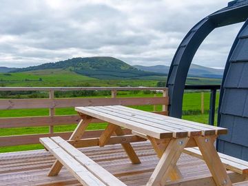 Exterior of pod with picnic table along with view