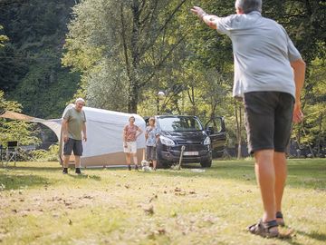 Grass pitches surrounded by greenery