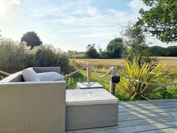 The sofa and coffee table which overlook the fields and a road in the distance. (added by visitor 19 aug 2021)