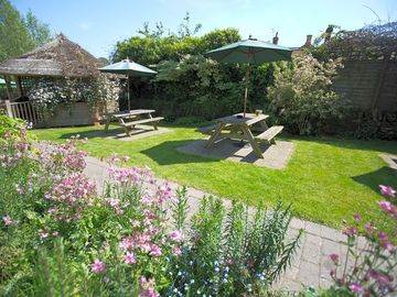Peaceful pub garden complete with thatched smoking shelter