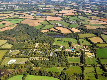 Aerial view of the site and its wooded surroundings