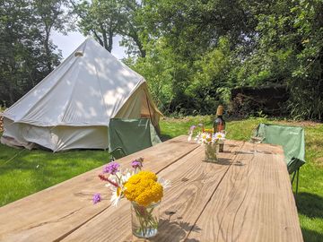 Bell tent and picnic table set with wild flowers from the wood (added by manager 28 jun 2022)