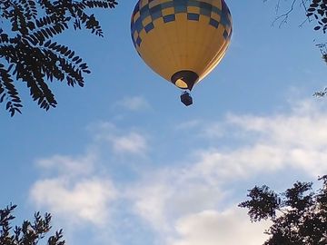 Chianti skies over clantenova filled with passing hot-air balloons.