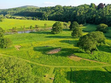Aerial view of site with mown pitches