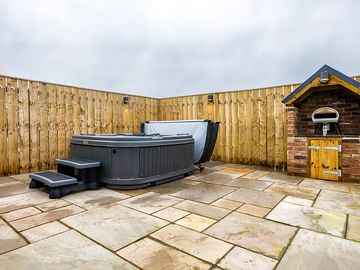 Private patio with hot tub, pizza oven and wooden furniture (added by manager 21 apr 2024)