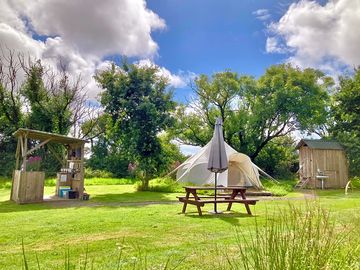 Each tent comes with its own private outdoor kitchen, toilet, shower room, fire pit and picnic table