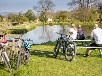 Family cycling by the pond