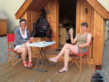 Enjoying a glass of wine outside the pod cabin