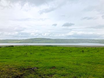 Campervan parking area with scenery and private beach access.