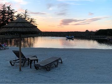 Pool and beach at sunset (added by manager 14 dec 2023)