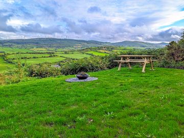 Private campsite pitch complete with picnic table, firepit and water/electricity included.