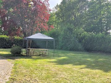 Tent pitch with shared picnic bench