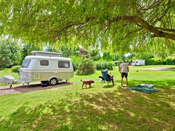 Vintage van on a hardstanding electric pitch on meadow brook field.