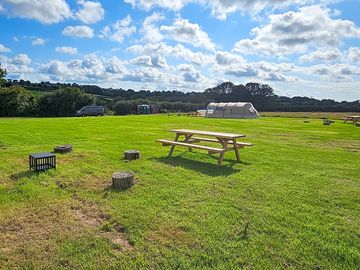 Each wild camping pitch has its own table, fire pit and log seats