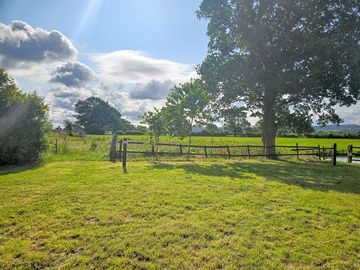 Scenic grass pitch near the pond