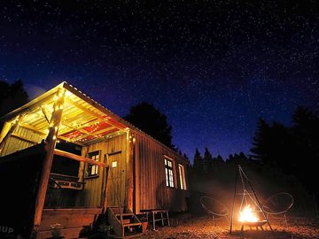 Cabin with a star-filled night sky