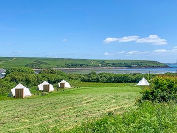 Glamping field with sea view at low tide