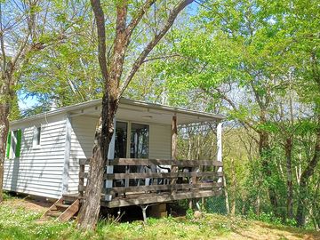 Cabin partly shaded by trees