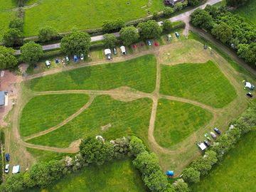 Drone image of the campsite showing the mown paths through the field and the generous pitches