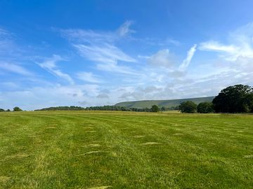 Level camping field with spectacular downs views