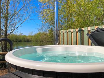 Private wood-fired hot tub overlooking the lake from lodge 3