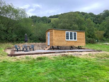 The shepherds hut has its own table and chairs and fire pit outside