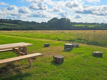 Each wild camping pitch has its own table, fire pit and log seats