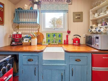 Kitchen with cooker, fridge, microwave, kettle and coffee machine