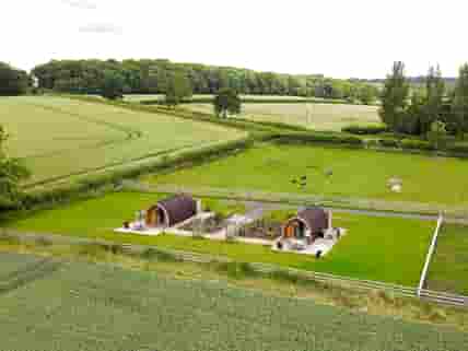 Glamping pods surrounded by friendly animals and green countryside
