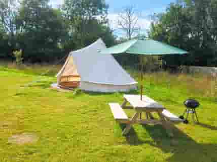 The Bell Tent, complete with picnic table and charcoal BBQ