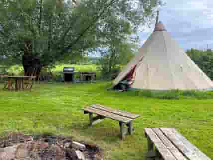 Tipi with outdoor seating, dining and cooking area