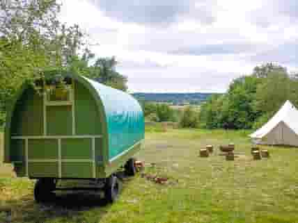 Green gypsy caravan with lovely rural views behind