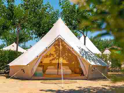 Bell tent on a partially shaded pitch