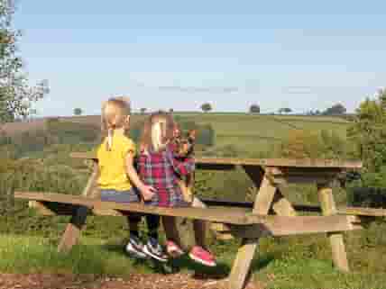 Children sitting on a picnic bench