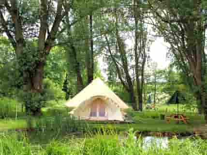 The new Baby-Bell Tent, nestled beneath the trees, overlooking it's own private pond.