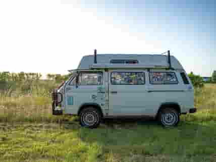 A small campervan parks up in the Big Sky campervan meadow