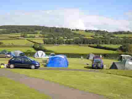 Non-electric grass pitches with views of Dartmoor
