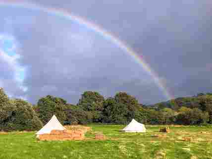Rainbow over the bell tents