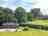 Midelney Manor: Cabin surrounded by trees (photo added by manager on 01/19/2024)