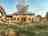 Dorset Nectar Orchard Campsite: The cider garden/sculpture garden with the tasting room, tap room and farm shop behind