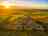 Lanyon Holiday Park: Aerial view of the site out to sea with a great sunset (photo added by manager on 08/22/2015)