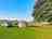 Longfield Farm: Visitor image of the non-electric camp pitch at top of site, with tree for morning shade