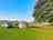 Longfield Farm: Visitor image of the non-electric camp pitch at top of site, with tree for morning shade 