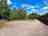Raker Lake Caravan Park: Gravel hardstanding and grass pitches beyond (photo added by manager on 05/07/2025)